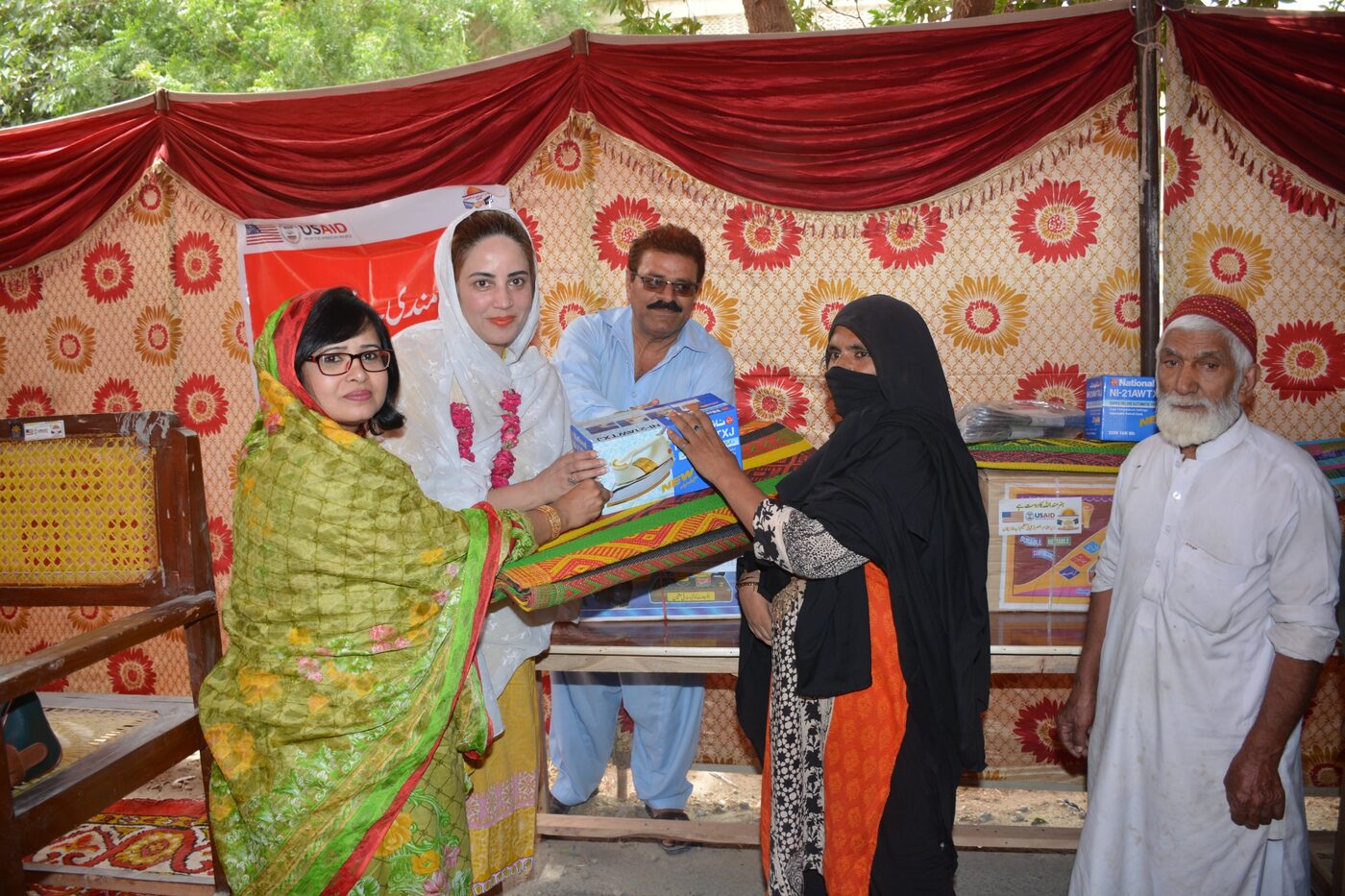 Woman receiving materials at a programme event