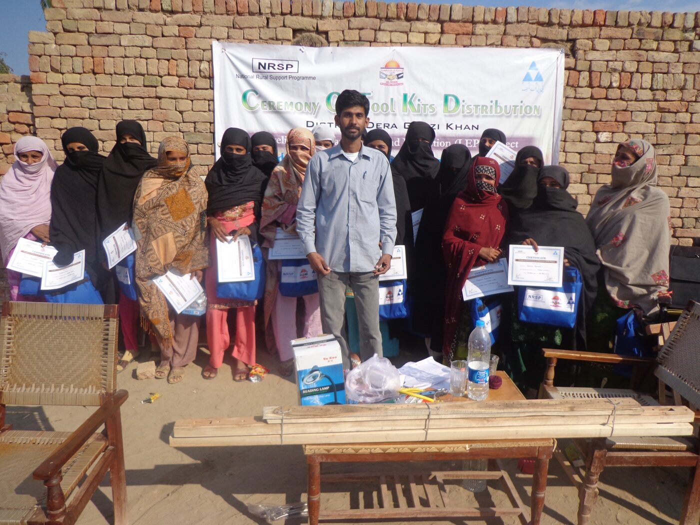 Women graduates with certificates and training kits