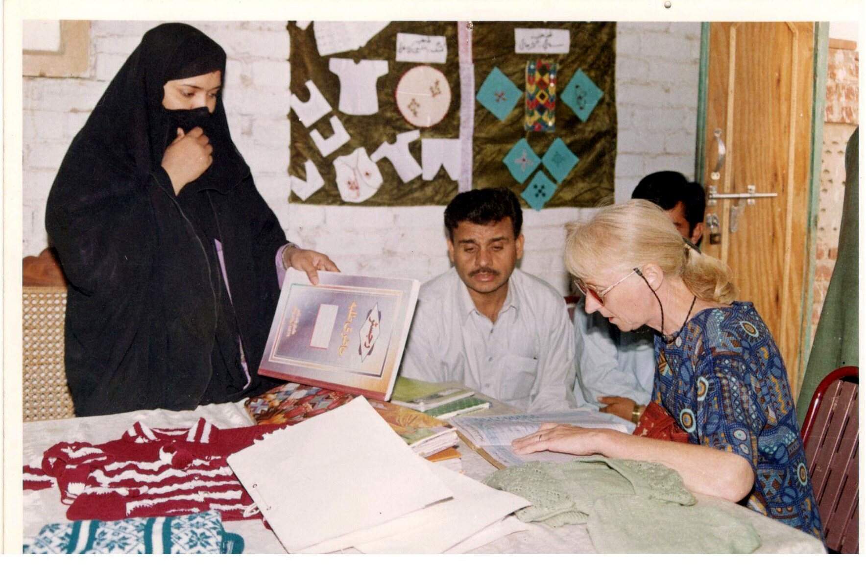 Programme representatives reviewing records and trainee work
